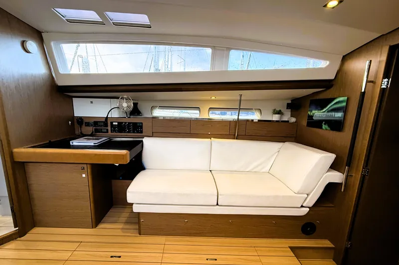 Slide: The Image of Interior of 2013 Jeanneau Sun Odyssey 44 DS yacht with modern wood finish and white sofa. - 8