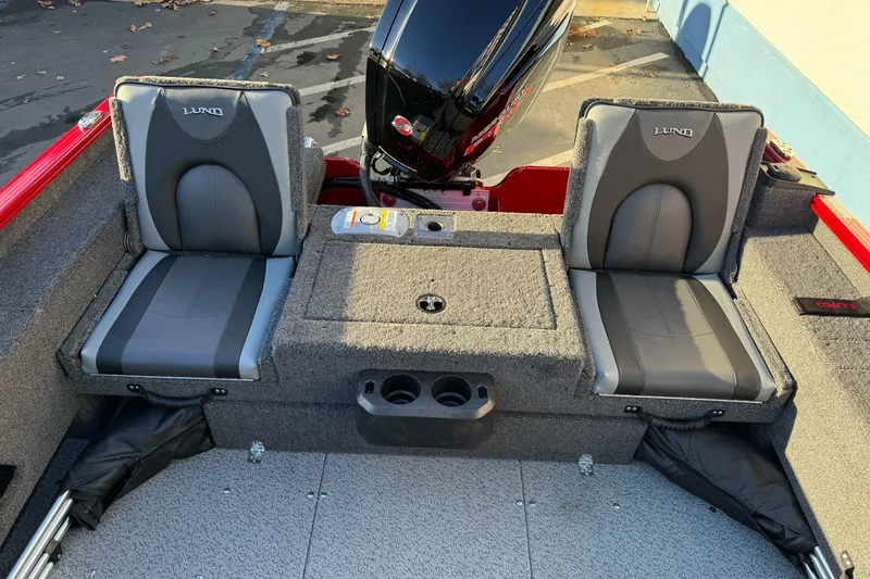 Slide: The Image of 2026 Lund 1775 Adventure Sport boat interior with dual seats and motor. - 12