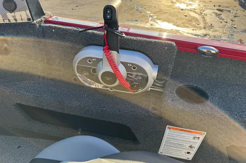 Slide: The Image of Control panel of 2026 Lund 1775 Adventure Sport boat with throttle and safety features. - 20