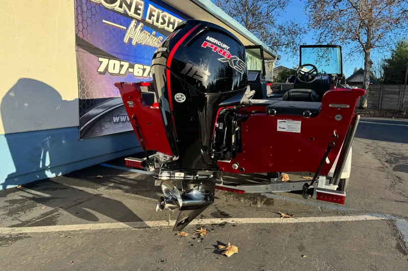 Slide: The Image of 2026 Lund 1775 Adventure Sport boat with Mercury Pro XS engine, parked outdoors. - 3