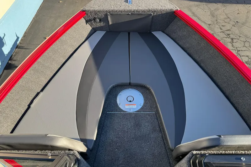 Slide: The Image of 2026 Lund 1775 Adventure Sport boat interior with red trim and gray seating. - 7