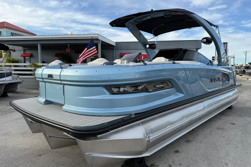 The Image of 2026 Avalon 2585 Excalibur Tri-toon boat with Mercury 400hp V-10 engine, docked. - 0