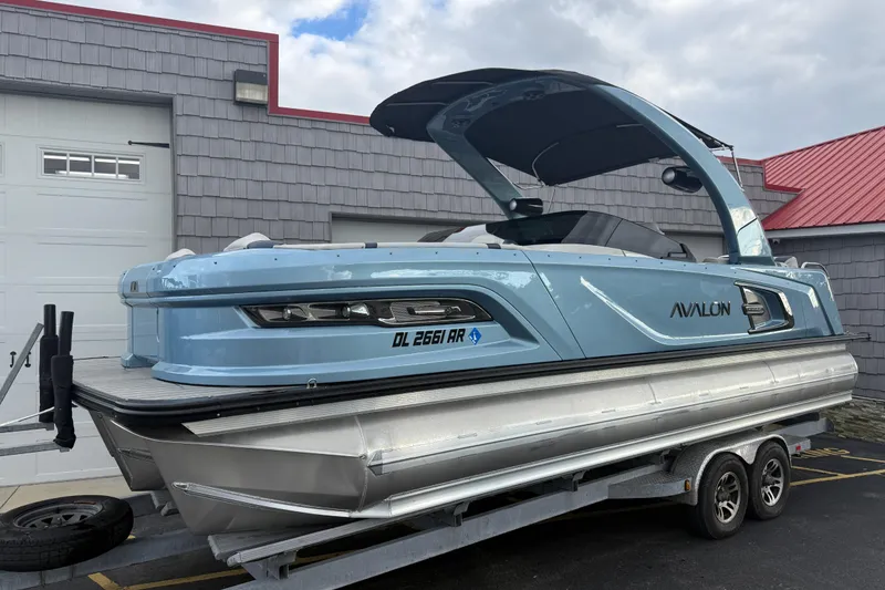 Slide: The Image of 2026 Avalon 2585 Excalibur Tri-toon boat with Mercury 400hp V-10 engine, docked. - 1