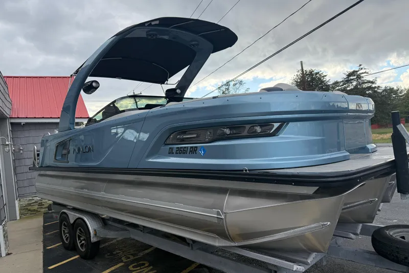 Slide: The Image of 2026 Avalon 2585 Excalibur boat with Mercury 400hp V-10 engine, docked under a sunny sky. - 10