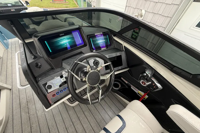 Slide: The Image of 2026 Avalon 2585 Excalibur boat interior with windshield, seating, and storage area. - 26