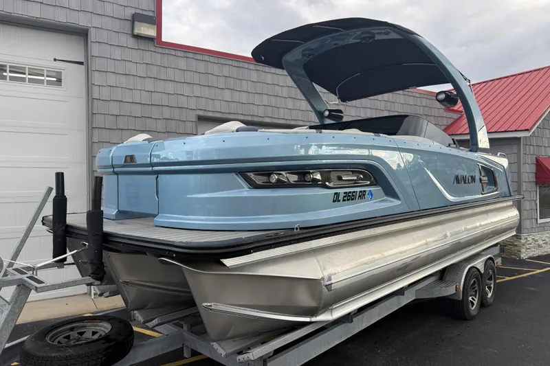 Slide: The Image of 2026 Avalon 2585 Excalibur Tri-toon boat with Mercury 400hp V-10 engine, docked. - 3
