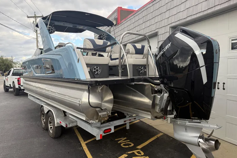 Slide: The Image of 2026 Avalon 2585 Excalibur Tri-toon with Mercury 400hp V-10 engine, parked outdoors. - 7