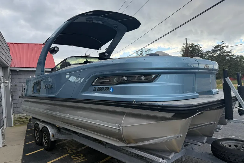 Slide: The Image of 2026 Avalon 2585 Excalibur Tri-toon with Mercury 400hp V-10 engine, docked outdoors. - 9