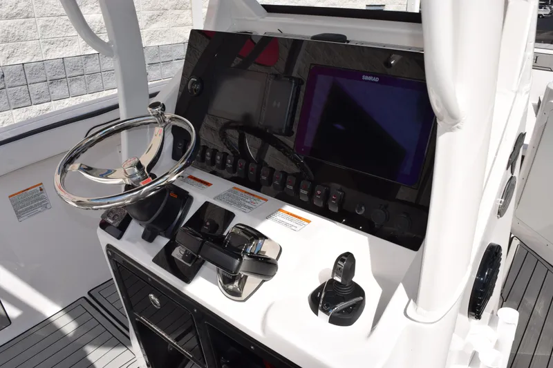 Slide: The Image of 2026 Yamaha Boats 255 FSH Sport H dashboard with steering wheel and control panel. - 12