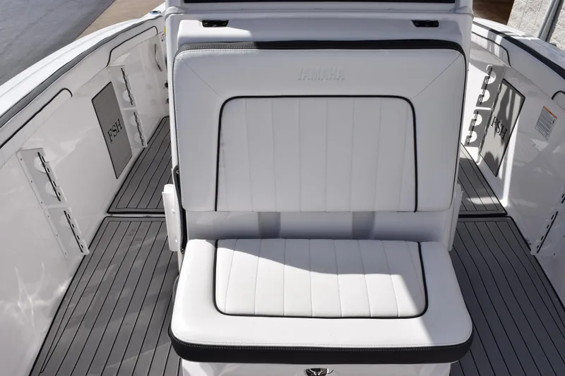 Slide: The Image of 2026 Yamaha Boats 255 FSH Sport H interior with white seating and sleek design. - 15