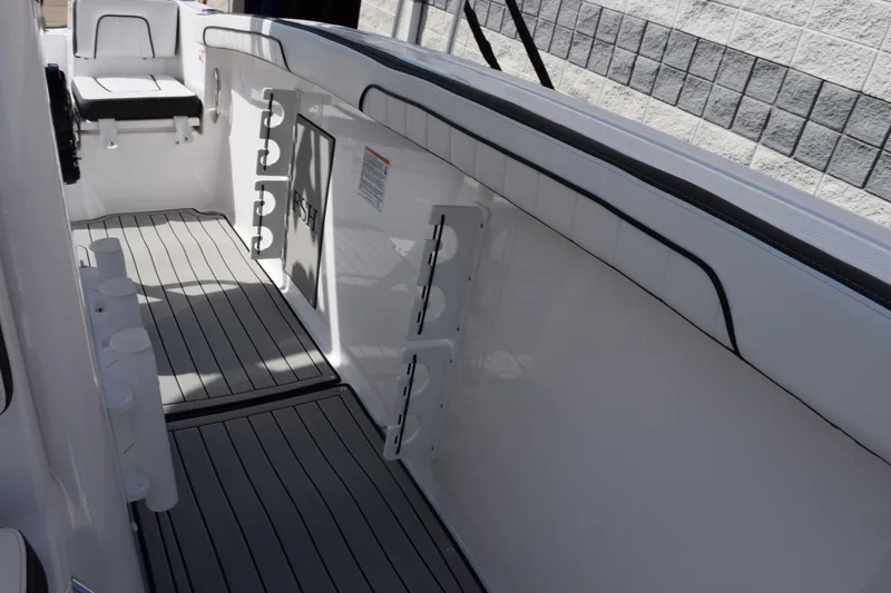 Slide: The Image of 2026 Yamaha Boats 255 FSH Sport H interior with sleek seating and rod holders. - 19