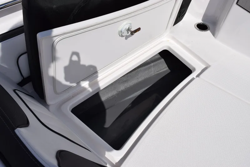 Slide: The Image of Open storage compartment on 2026 Yamaha Boats 255 FSH Sport H, featuring sleek design and secure latch. - 20