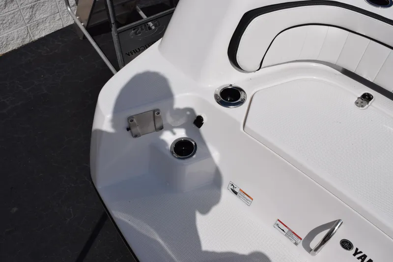 Slide: The Image of 2026 Yamaha Boats 255 FSH Sport H deck with seating and cup holders. - 7