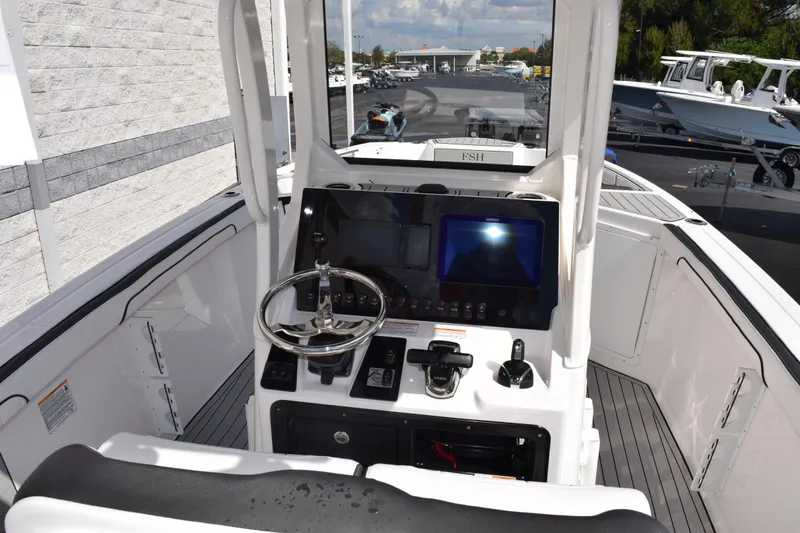 Slide: The Image of 2026 Yamaha Boats 255 FSH Sport H helm with modern controls and navigation display. - 9