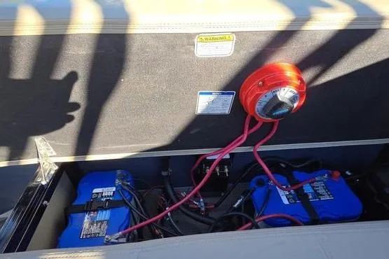 Slide: The Image of 2017 Regency 254 DL3 boat battery compartment with wiring and switch. - 11