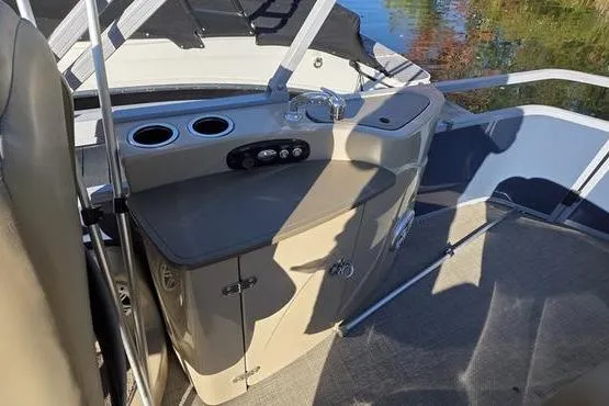 Slide: The Image of 2017 Regency 254 DL3 boat interior with helm station and cup holders. - 14