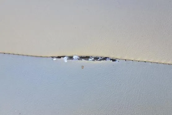 Slide: The Image of Torn upholstery on 2017 Regency 254 DL3 boat seat, showing damage and wear. - 17