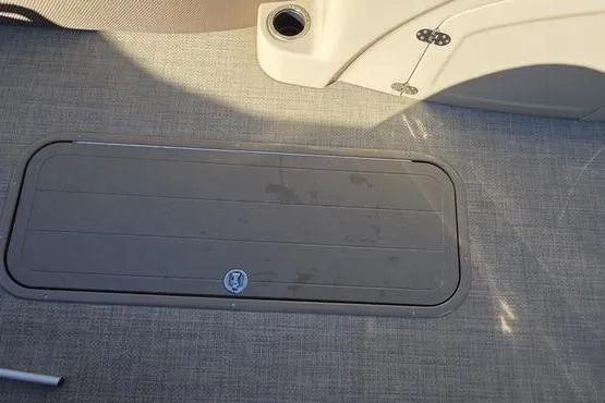 Slide: The Image of 2017 Regency 254 DL3 boat floor with storage compartment and cup holder. - 22