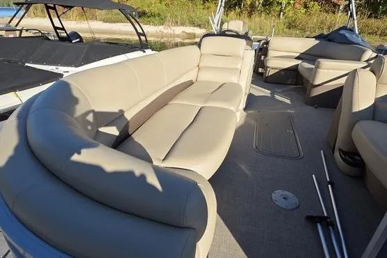 Slide: The Image of 2017 Regency 254 DL3 pontoon boat with spacious beige seating and sunlit deck. - 24