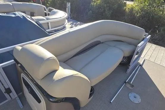 Slide: The Image of 2017 Regency 254 DL3 pontoon boat with beige seating and spacious deck area. - 25