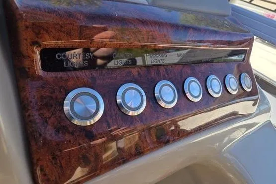 Slide: The Image of Control panel of a 2017 Regency 254 DL3 boat with multiple buttons. - 26