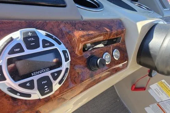 Slide: The Image of Dashboard of 2017 Regency 254 DL3 with Kenwood audio system and wood finish. - 29