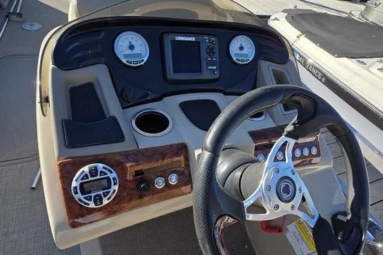 Slide: The Image of 2017 Regency 254 DL3 boat dashboard with steering wheel and control panel. - 4