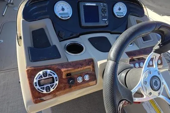 Slide: The Image of 2017 Regency 254 DL3 boat dashboard with steering wheel and control panel. - 5