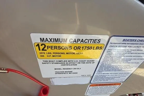 Slide: The Image of 2017 Regency 254 DL3 boat capacity label, max 12 persons or 1750 lbs, 300 HP motor. - 7