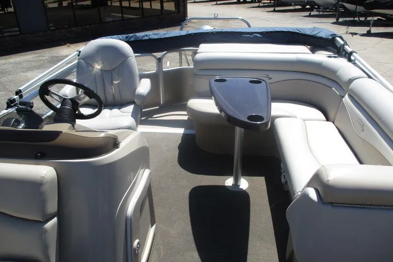Slide: The Image of 2013 Bennington 20SL pontoon boat interior with seating and steering wheel. - 4