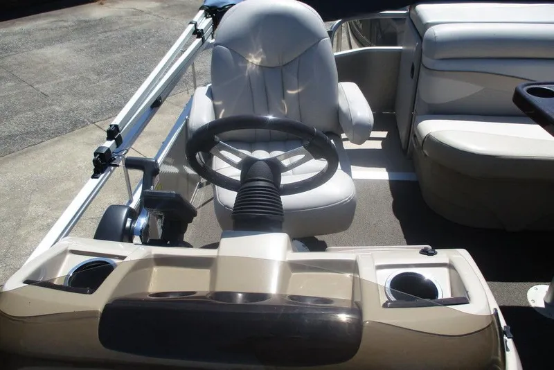 Slide: The Image of 2013 Bennington 20SL boat interior with steering wheel and seating area. - 5