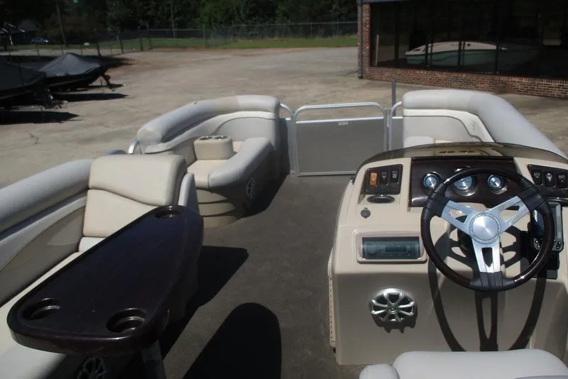 Slide: The Image of 2013 Bennington 20SL pontoon boat interior with steering console and seating area. - 7
