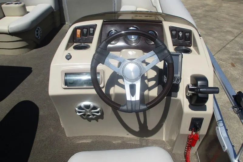 Slide: The Image of Steering console of a 2013 Bennington 20SL boat with controls and gauges. - 8