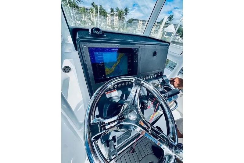 Slide: The Image of Helm of 2021 Crevalle 26 HCO boat with navigation display and steering wheel. - 13