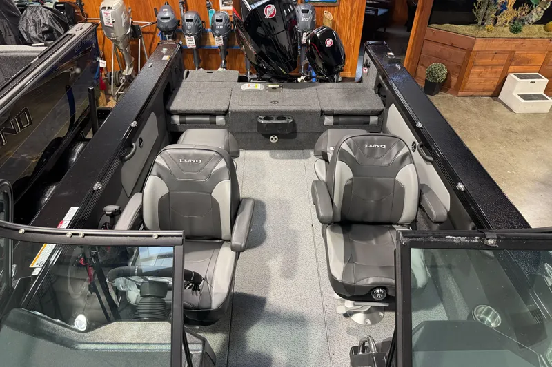 Slide: The Image of Interior of 2026 Lund 1975 Tyee boat with two seats and motor display. - 14