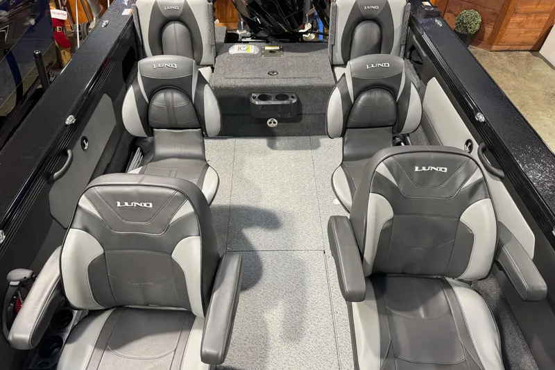 Slide: The Image of Interior of 2026 Lund 1975 Tyee boat with gray and black seating. - 16