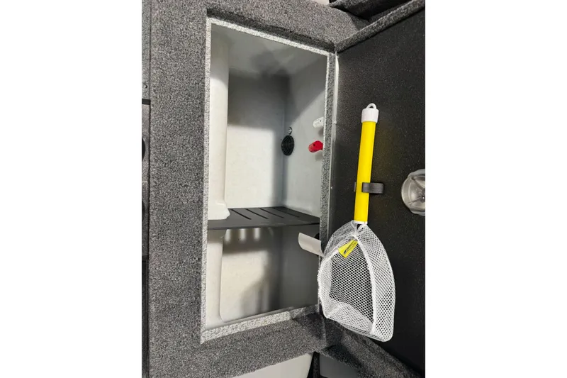 Slide: The Image of Interior of 2026 Lund 1975 Tyee boat with storage compartment and fishing net. - 28