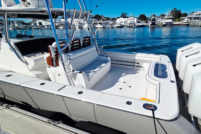 Slide: The Image of 2024 Valhalla Boatworks V-41, sleek design, docked in a marina with clear blue water. - 15