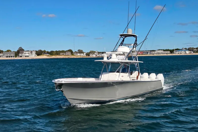 Slide: The Image of 2024 Valhalla Boatworks V-41 cruising on open water near coastal homes. - 8