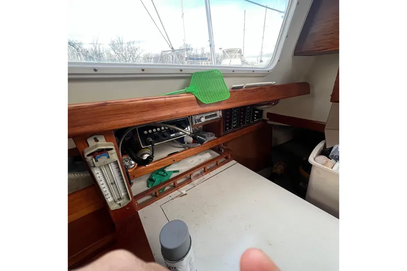 Slide: The Image of 1975 Ranger Yachts 33 interior with navigation equipment and wooden finish. - 4