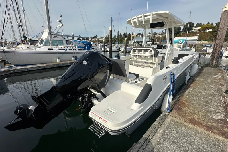 Slide: The Image of 2023 Bayliner Trophy T24CC boat docked at marina with outboard motor. - 15