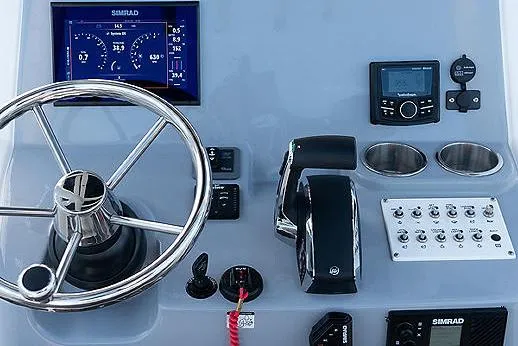 Slide: The Image of 2023 Bayliner Trophy T24CC boat with open storage compartment and cup holders. - 4