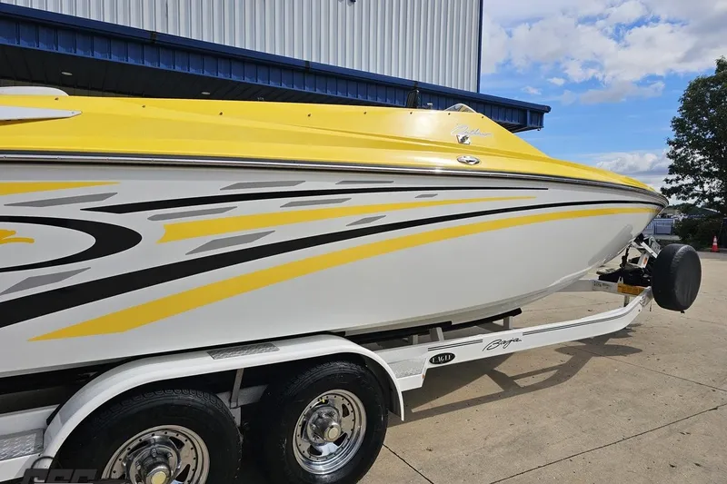 Slide: The Image of 2007 Baja 26 Outlaw boat with yellow and white design on a trailer. - 10