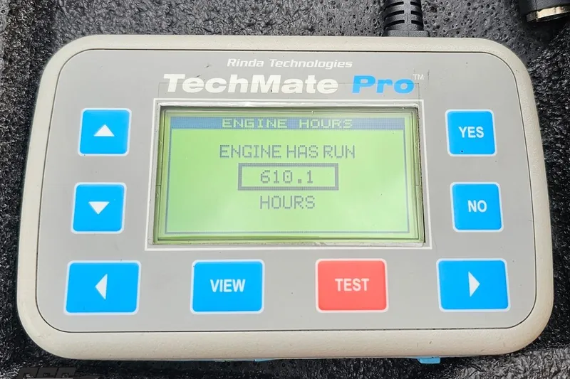 Slide: The Image of Digital display showing engine hours: 610.1 on TechMate Pro device. - 100