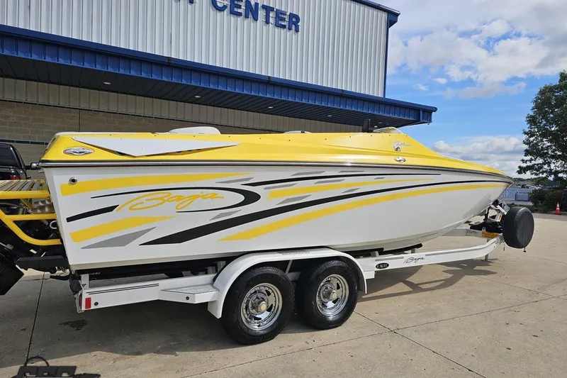 Slide: The Image of 2007 Baja 26 Outlaw boat with yellow and white design on a trailer. - 11