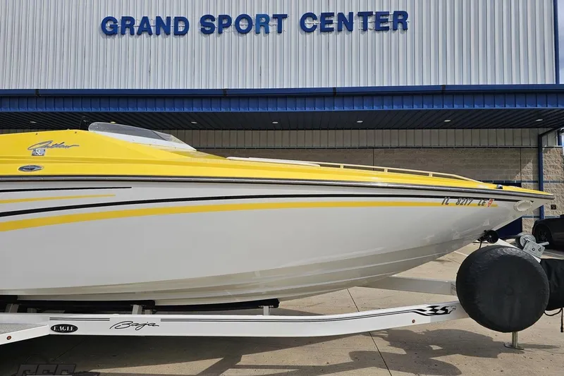 Slide: The Image of 2007 Baja 26 Outlaw boat in yellow and white at Grand Sport Center. - 12