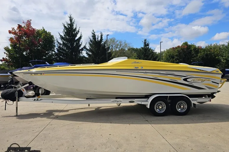Slide: The Image of 2007 Baja 26 Outlaw boat with yellow and white design on a trailer. - 21