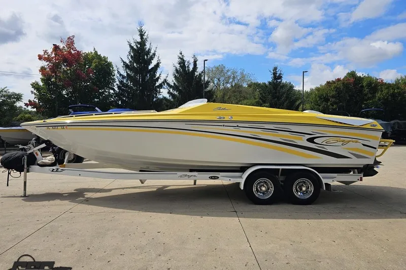 Slide: The Image of 2007 Baja 26 Outlaw speedboat with yellow and white design on a trailer. - 22