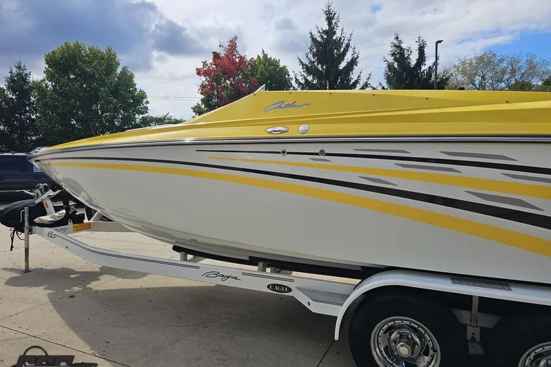 Slide: The Image of 2007 Baja 26 Outlaw boat with yellow and white design on trailer. - 27