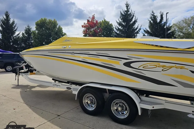 Slide: The Image of 2007 Baja 26 Outlaw boat with yellow and white design on a trailer. - 28